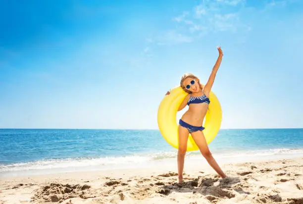 Photo of Happy girl enjoying summer vacations at the beach