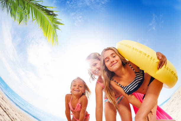 Happy girls having fun on exotic beach in summer
