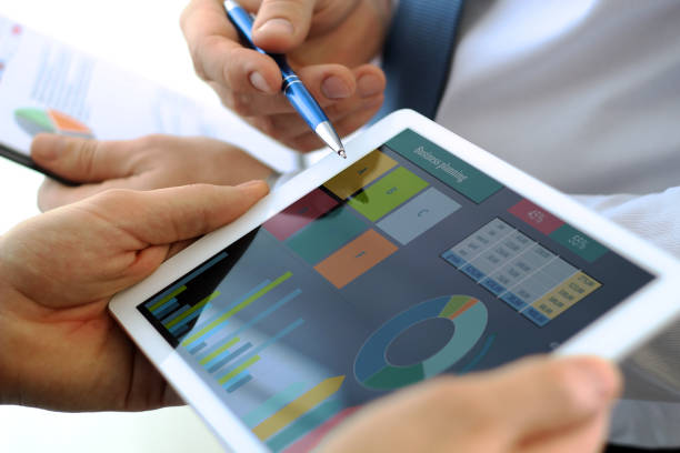 istock Business colleagues working and analyzing financial figures / graphs on a digital tablet 871346146