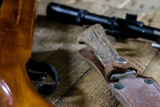 istock shooting, pneumatic and firearms on a wooden table. Table on the shooting range, weapons and shooting accessories. black background 871346326
