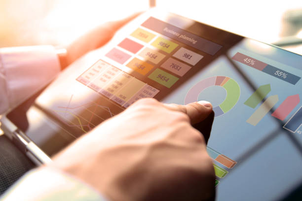 istock Business man working and analyzing financial figures on a graphs using laptop 871346380