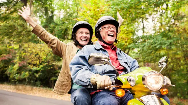 Photo of Happy Senior Couple on Scooter