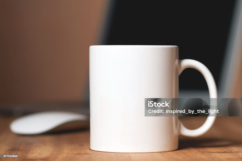 White mug on the desktop White mug on the wooden table Mug Stock Photo