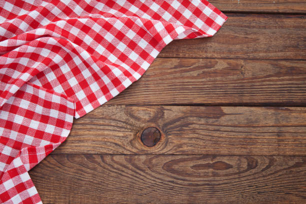 istock Old vintage wooden table with a red checkered tablecloth. Top view mockup. 871358666