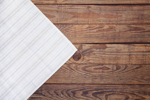 istock Old vintage wooden table with a red checkered tablecloth. Top view mockup. 871358670