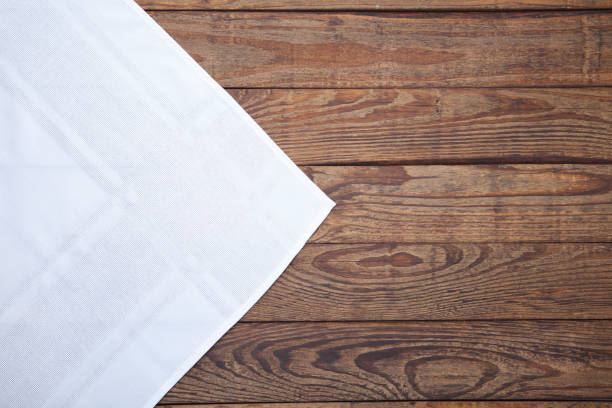 istock Old vintage wooden table with white tablecloth. Top view mockup. 871358690