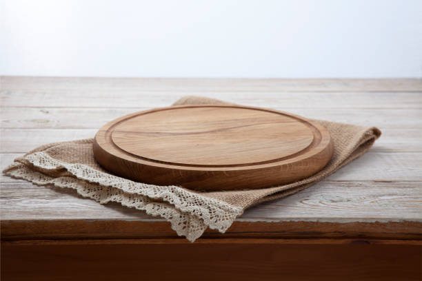 istock Pizza board, canvas napkin with lace on wooden table. Top view mock up 871358736