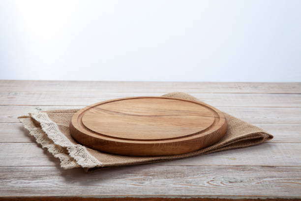 istock Pizza board, canvas napkin with lace on wooden table. Top view mock up 871358746