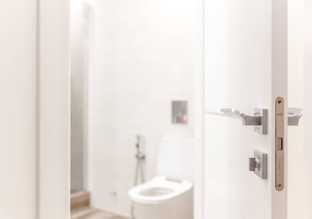 Open door in bathroom with toilet
