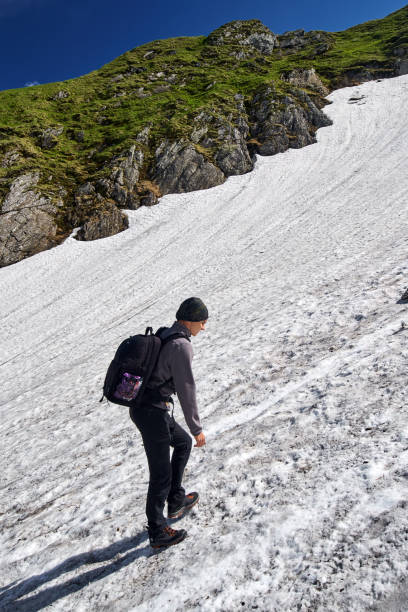 istock Young man on a steep trail in the mountains 871361318
