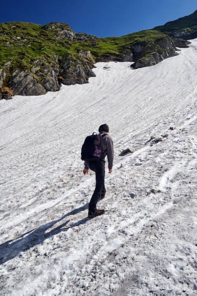 istock Young man on a steep trail in the mountains 871361320