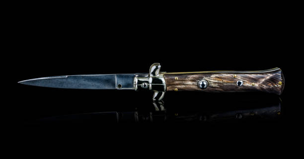 istock Beautiful handmade Italian switch blade knife isolated on black background. 871362258