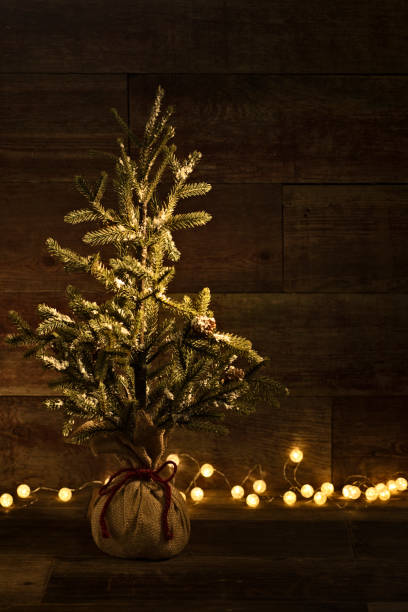 istock Christmas tree on retro wood background with bulb lights 871365366