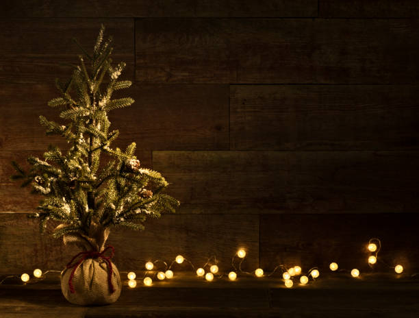istock Christmas tree on retro wood background with bulb lights 871365900