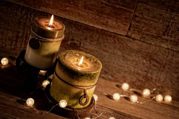 istock Candles with Christmas lights on retro wood background 871369176