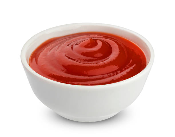 Bowl of ketchup isolated on white background