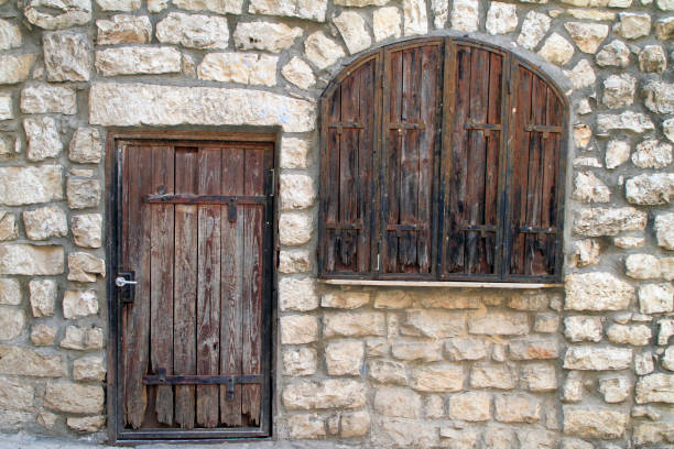 Closed door and window in a house made of stone