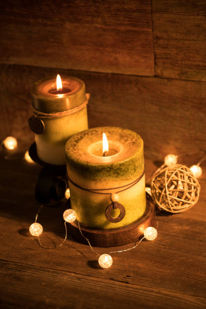 istock Candles with Christmas lights on retro wood background 871372738