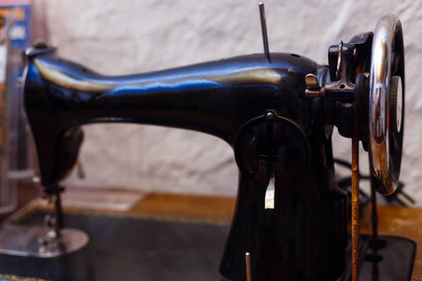 istock Black retro sewing machine in an old house 871373552