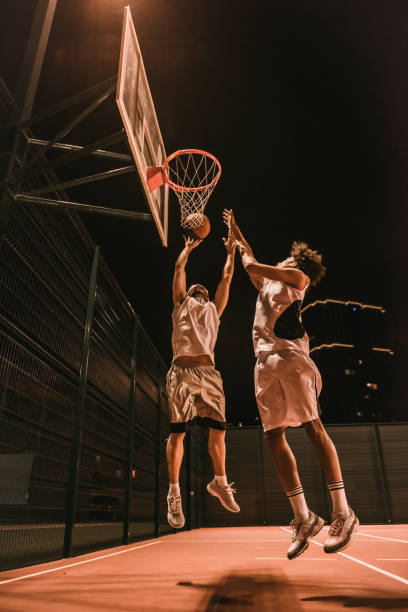Guys playing basketball stock photo