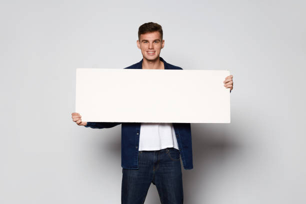 istock Casual Man holding white papper card on white background 871384802