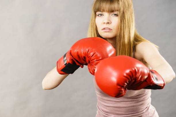 istock Woman wearing boxing gloves 871390682
