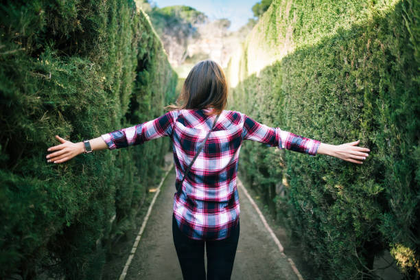 Young woman walking in the park labyrinth