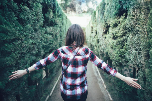 istock Young woman walking in the park labyrinth 871391768