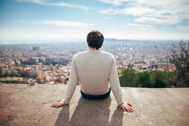 istock young man enjoying Barcelona city view 871392010