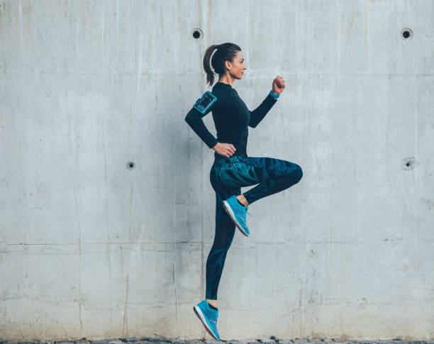 istock Woman jumping outdoors 871395522