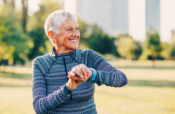 istock Senior sportswoman using a smart watch 871395544
