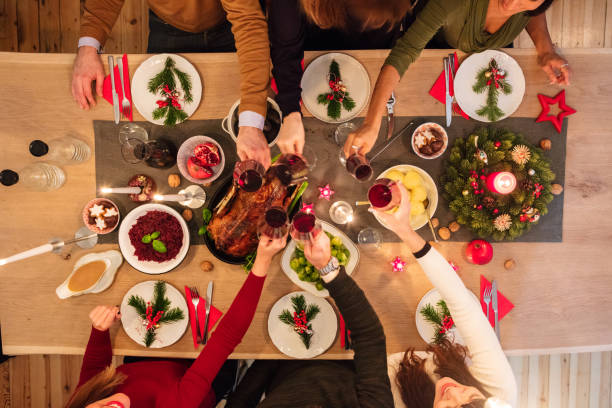 istock Overhead view of friends at table during christmas dinner 871398062