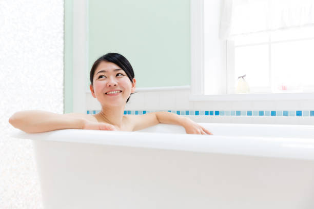 istock young asian woman in bathroom 871402648