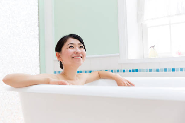 istock young asian woman in bathroom 871402654