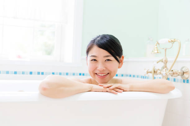 istock young asian woman in bathroom 871402680