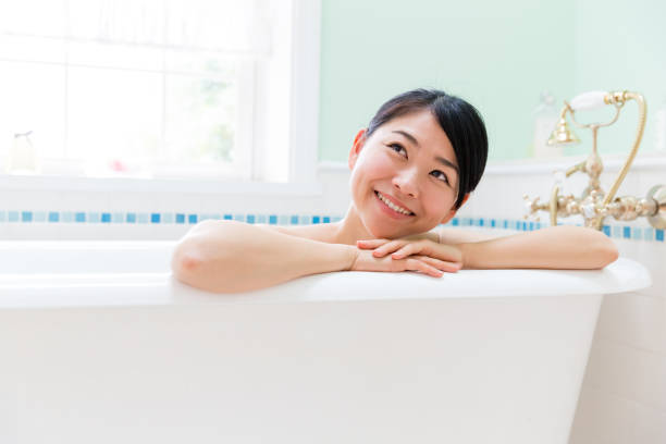 istock young asian woman in bathroom 871402710