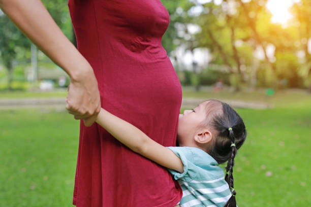 istock Happy Sister Hugging Pregnant Mother. 871406586