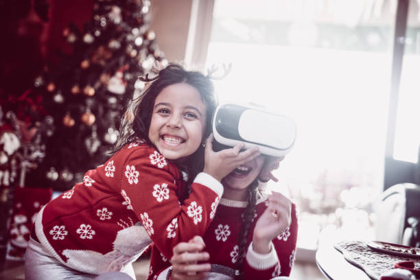 istock Two Little Sisters Playing and Fighting over Virtual Reality Simulator 871406674