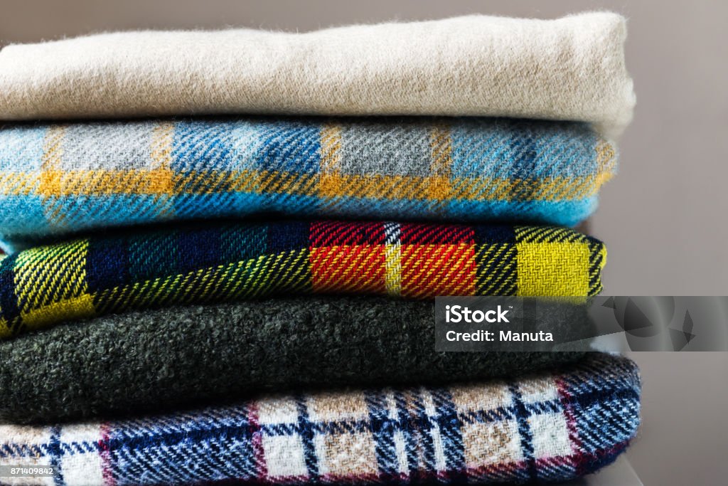 Stack of woolen checked blankets Stack of woolen checked blankets, autumn and winter concept Blanket Stock Photo