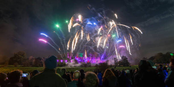 istock People watching Fireworks display at bonfire 4th of November celebration, Kenilworth Castle, united kingdom. 871410178