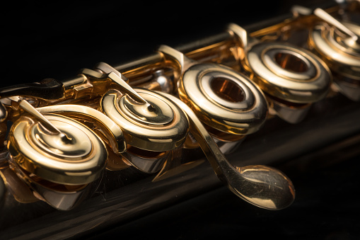 Details, keys of a golden flute black background
