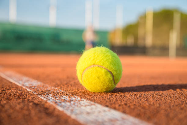 istock Tennis ball on white line 871413100