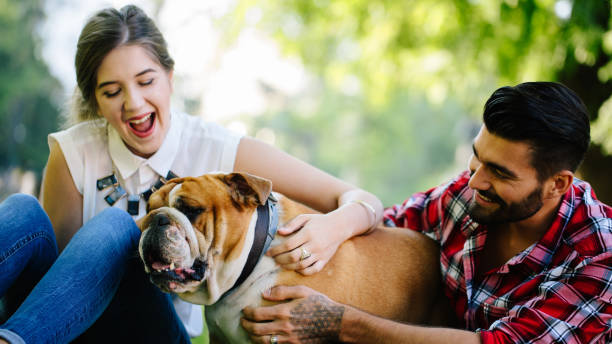 istock Young happy couple with dog 871414078