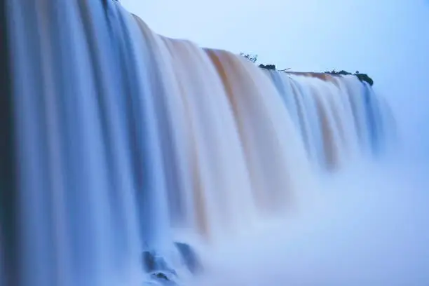 Photo of Impressive Iguacu falls landscape, blurred motion from long exposure at peaceful dawn - Idyllic Devil's Throat - international border of Brazilian Foz do Iguacu, Parana, Argentina Puerto Iguazu, Misiones and Paraguay - South America