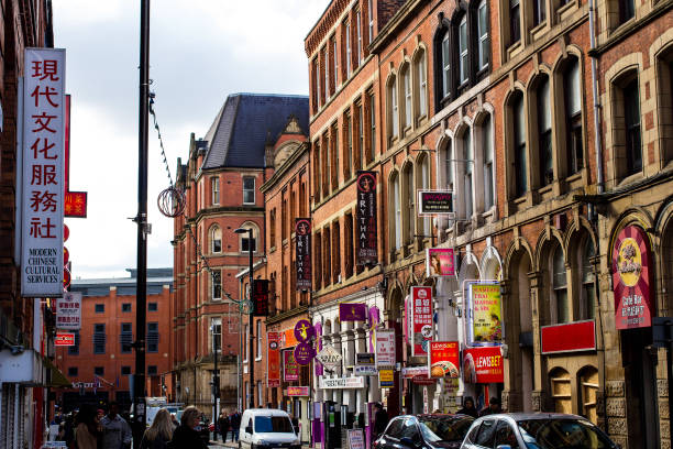 MANCHESTER, UNITED KINGDOM - 5 March, 2016: A busy street with Chinese restaurants and stores in the Chinatown part of Manchester.