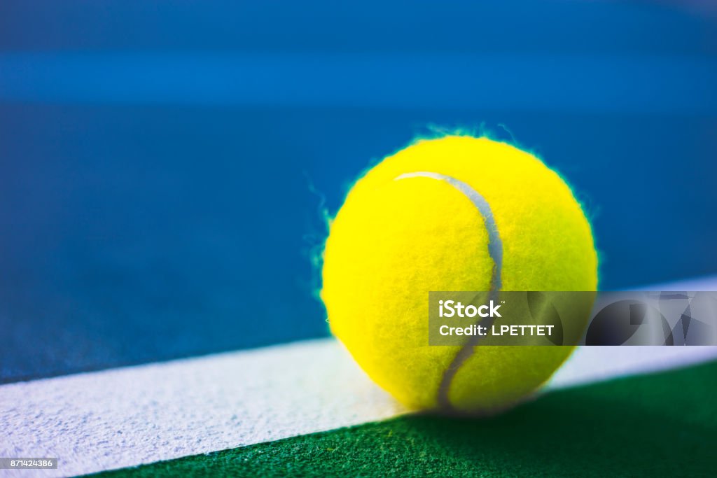 Tennis Ball A stock photo of a Tennis ball on the lines of a Tennis Court Backgrounds Stock Photo