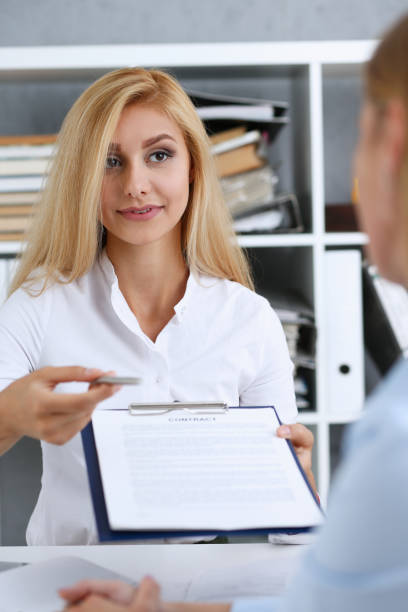 istock Female arm in white shirt offer contract form 871427974