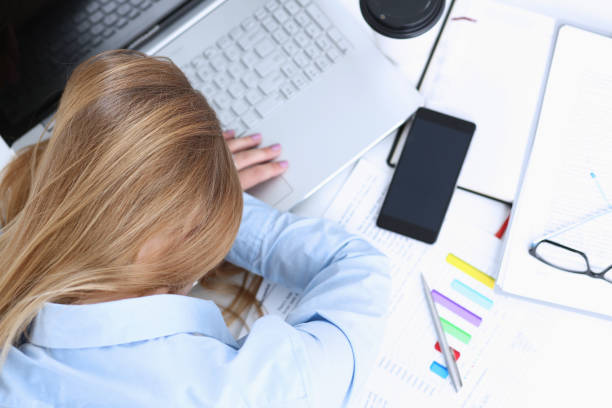 istock Tired businesswoman at workspace in office 871428046