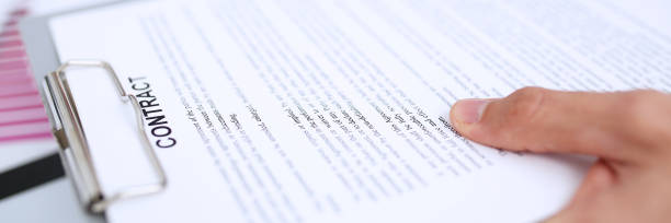 istock Male arm in suit offer contract form on clipboard pad 871428242