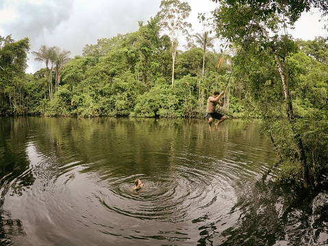 Family enjoys a guided exploration of the Amazon jungle on a remote part of the river.